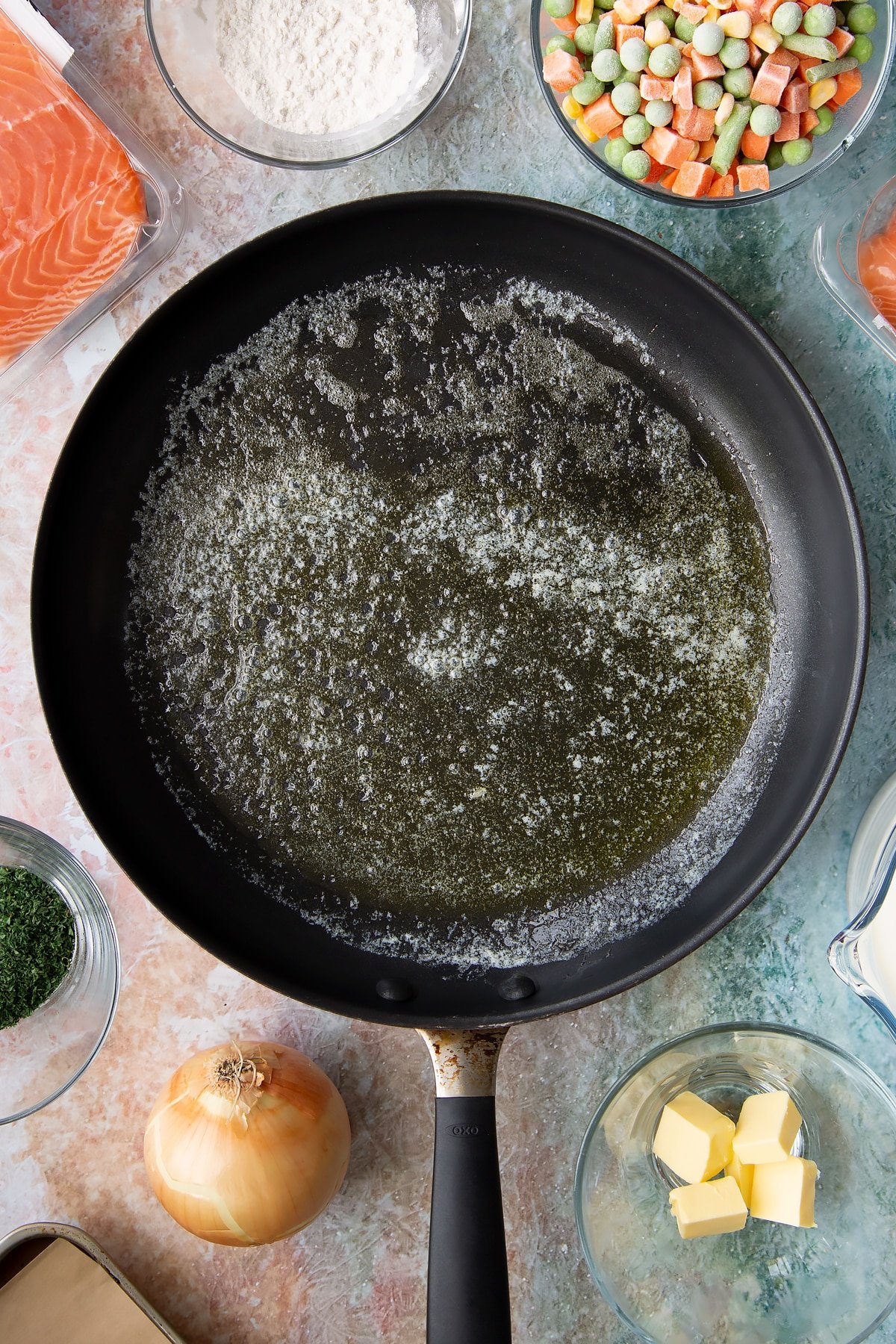 Overhead shot of a large frying pan with oil.