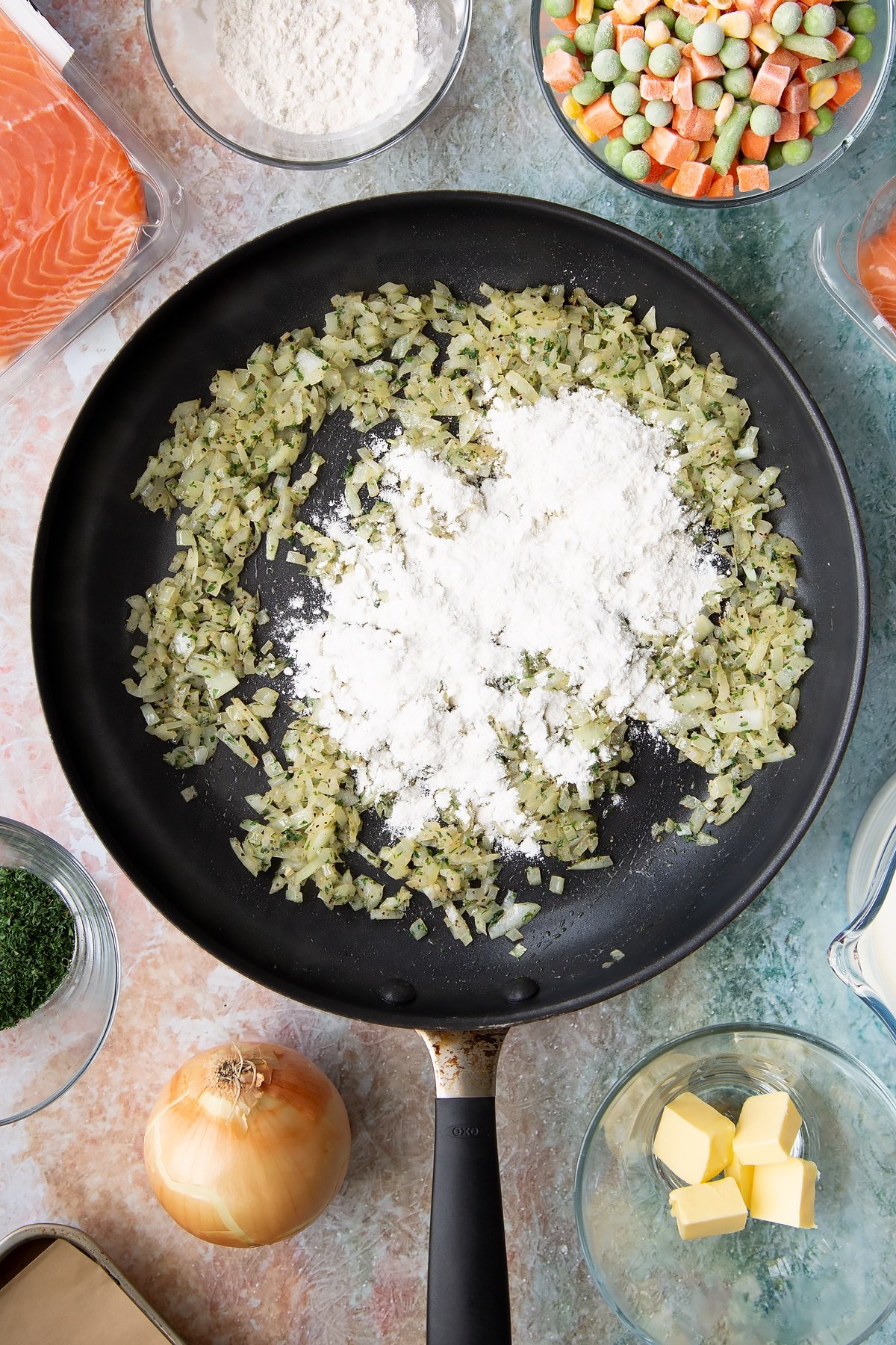 Adding flour to the frying pan.