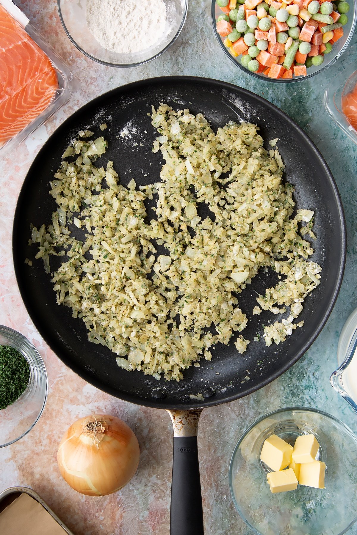 Overhead shot after the flour has melted into the onions within the frying pan.