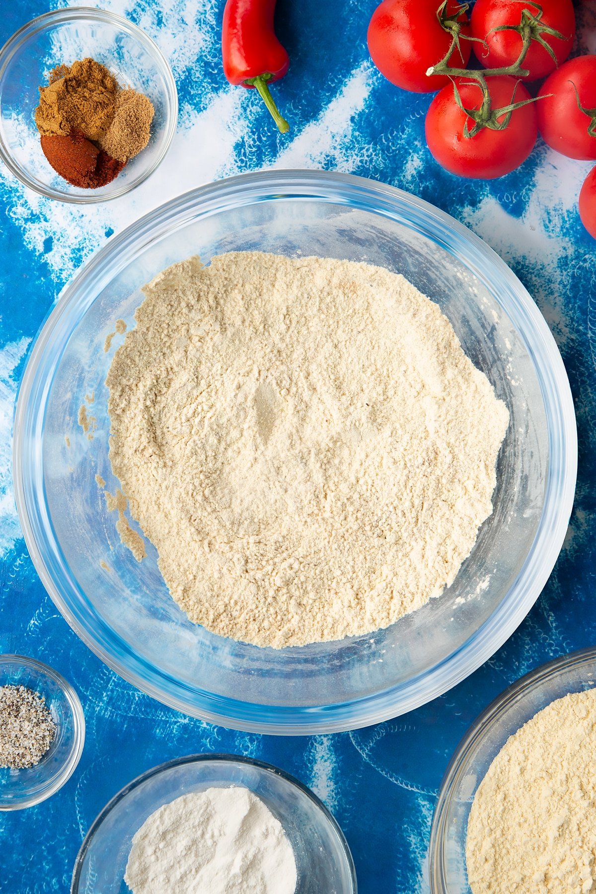 Overhead shot of the dry ingredients for the tomato pakora having been mixed together.